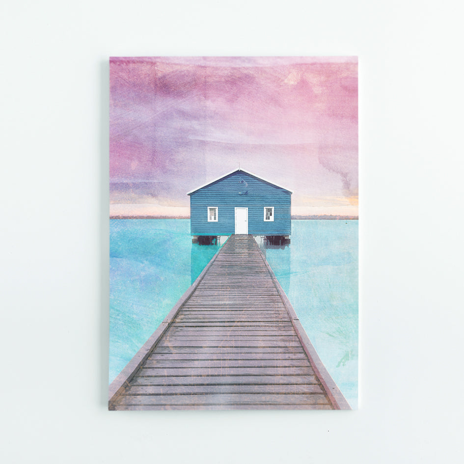 A5 Journal with illustration of the blue Crawley Boathouse at the end of the pier with turquoise water and pink sky. 