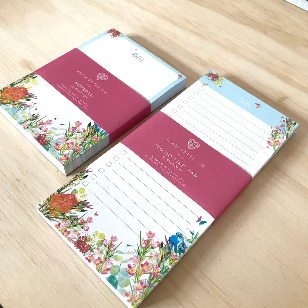 Lined to do list notepad with blue wren bird, butterflies and Australian native flora illustration next to a notepad with the same design.