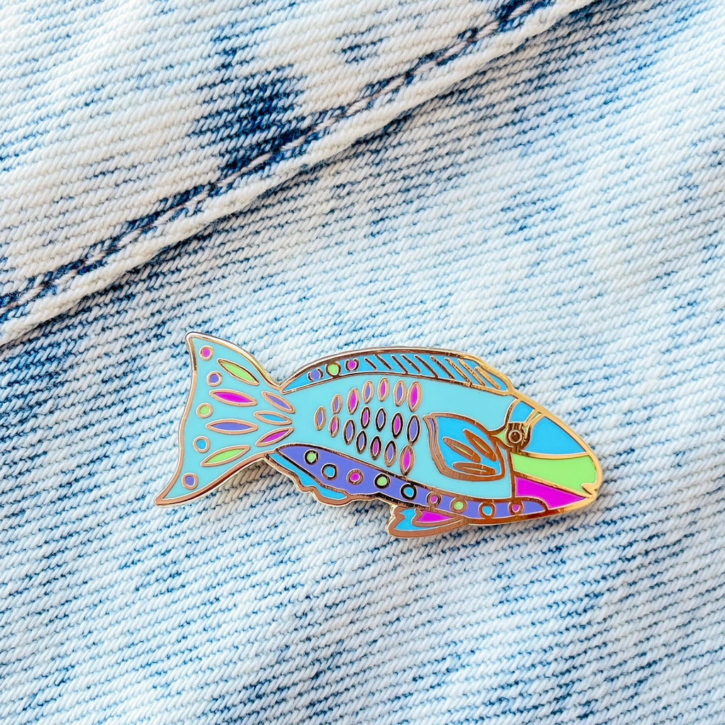Colourful Parrotfish enamel pin on a denim background