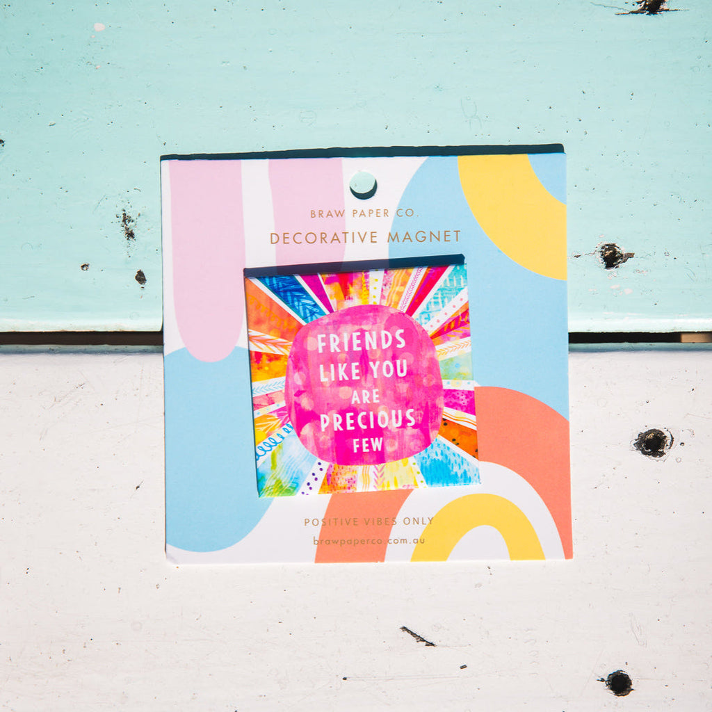 Decorative positive affirmation magnet with colourful design and text on a textured surface