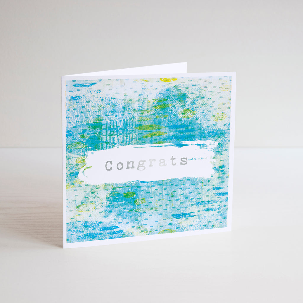 Square Congrats greetings card with silver foiling on blue, yellow and green background.