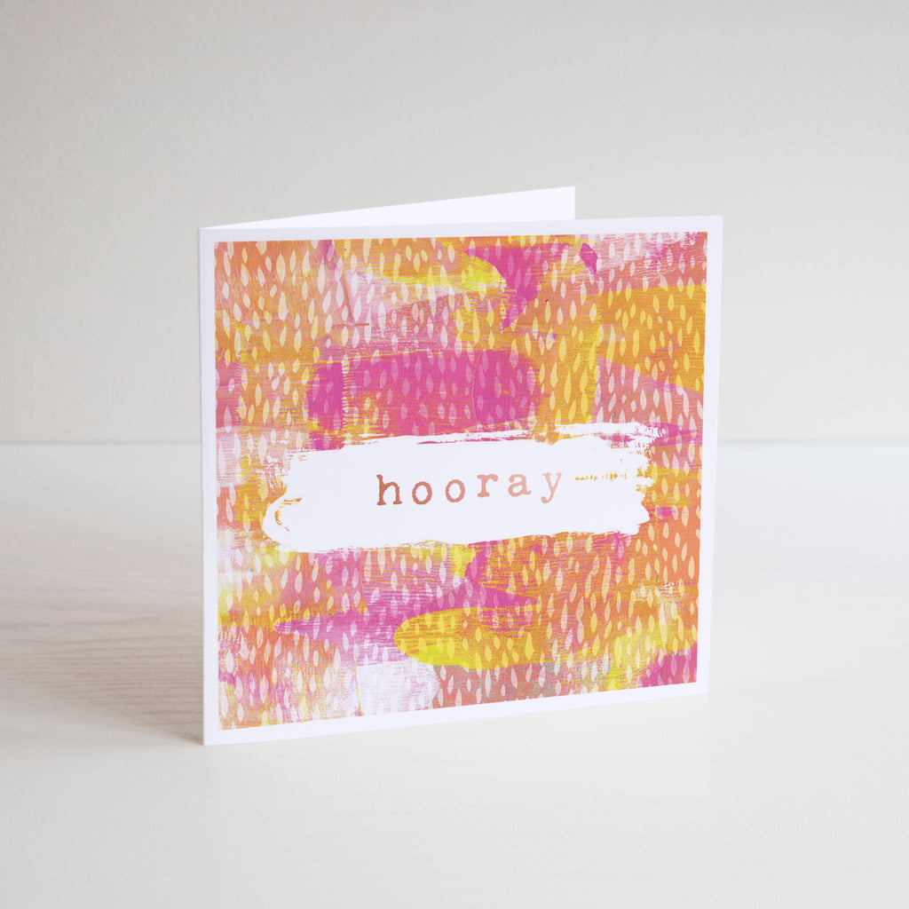Square, Hooray, greetings card with foiling on pink, yellow, orange and white background.