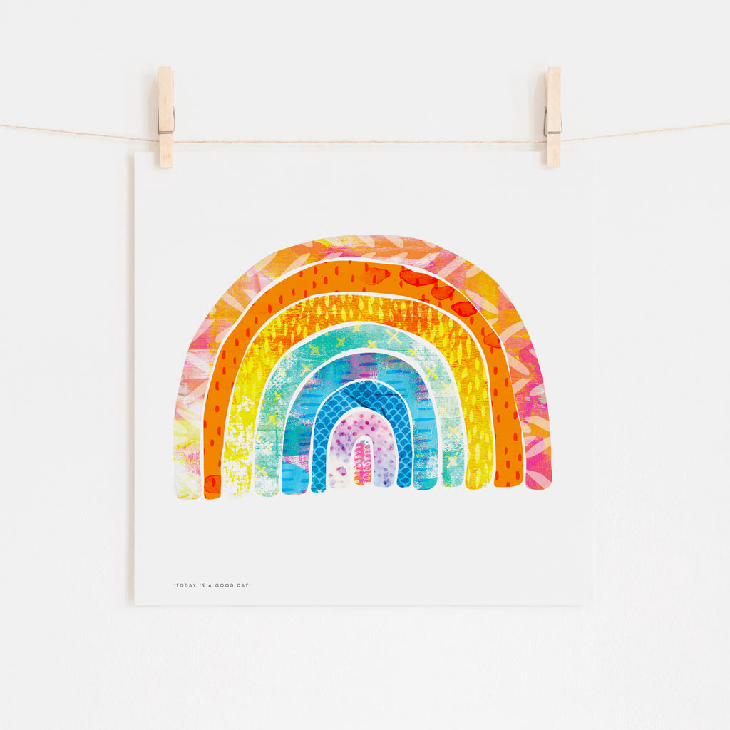 Today is a Good Day colourful rainbow  illustration art print on a white background hanging on a twine with two wooden pegs.