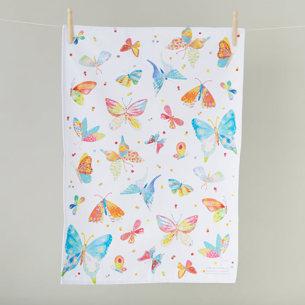 White tea towel with a bright, colourful butterfly illustration.