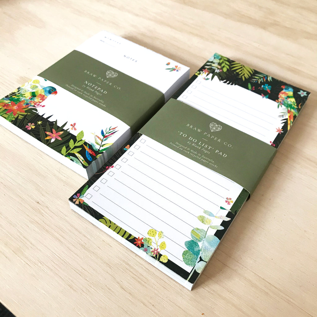 Lined to do list notepad with lorikeet bird, butterflies and Australian native flora illustration next to a notepad with the same design.