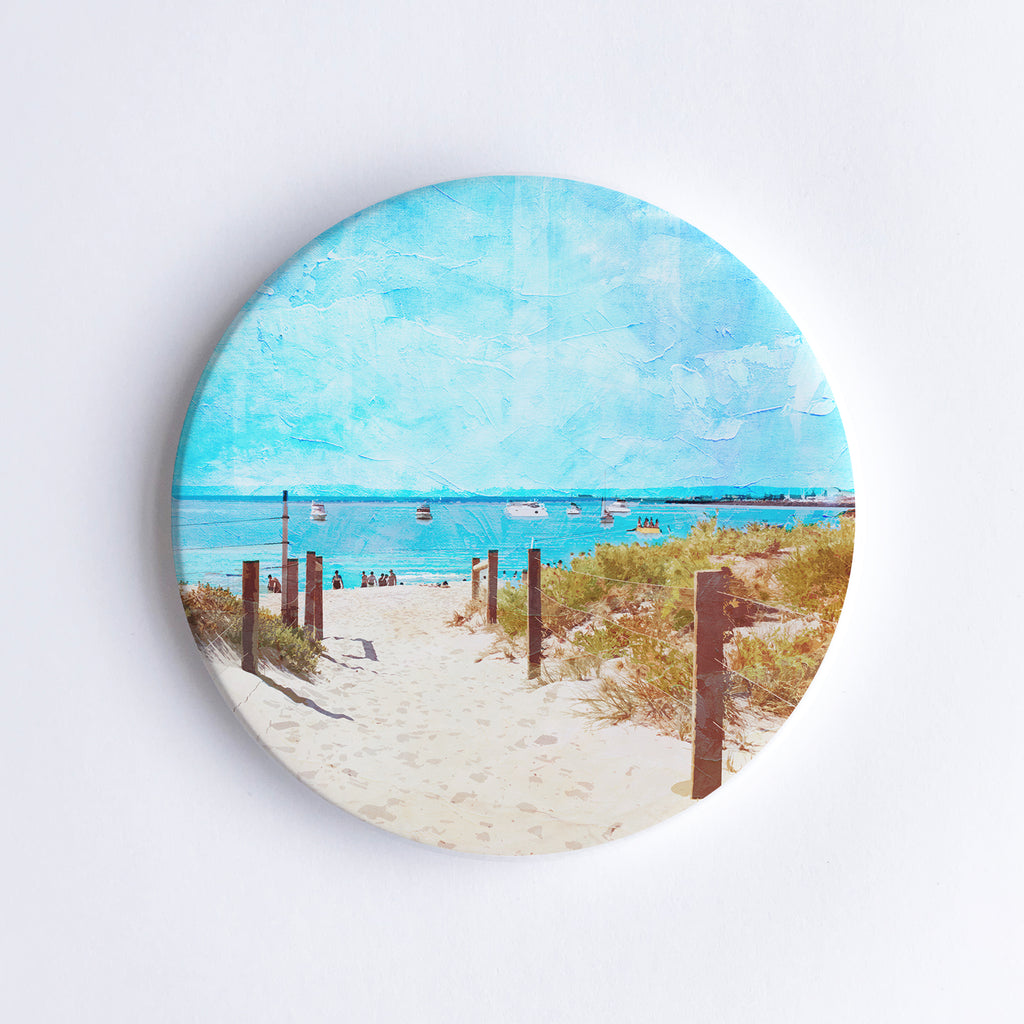 Round, hand printed ceramic coaster with illustration of South Beach in Western Australia showing a sand path through the dunes.