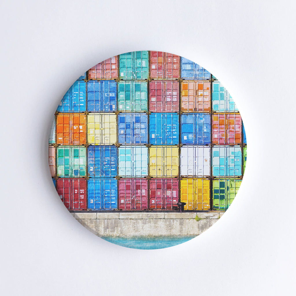 Round, hand printed ceramic coaster with illustration of colourful shipping containers at Fremantle Harbour stacked on top of each other.